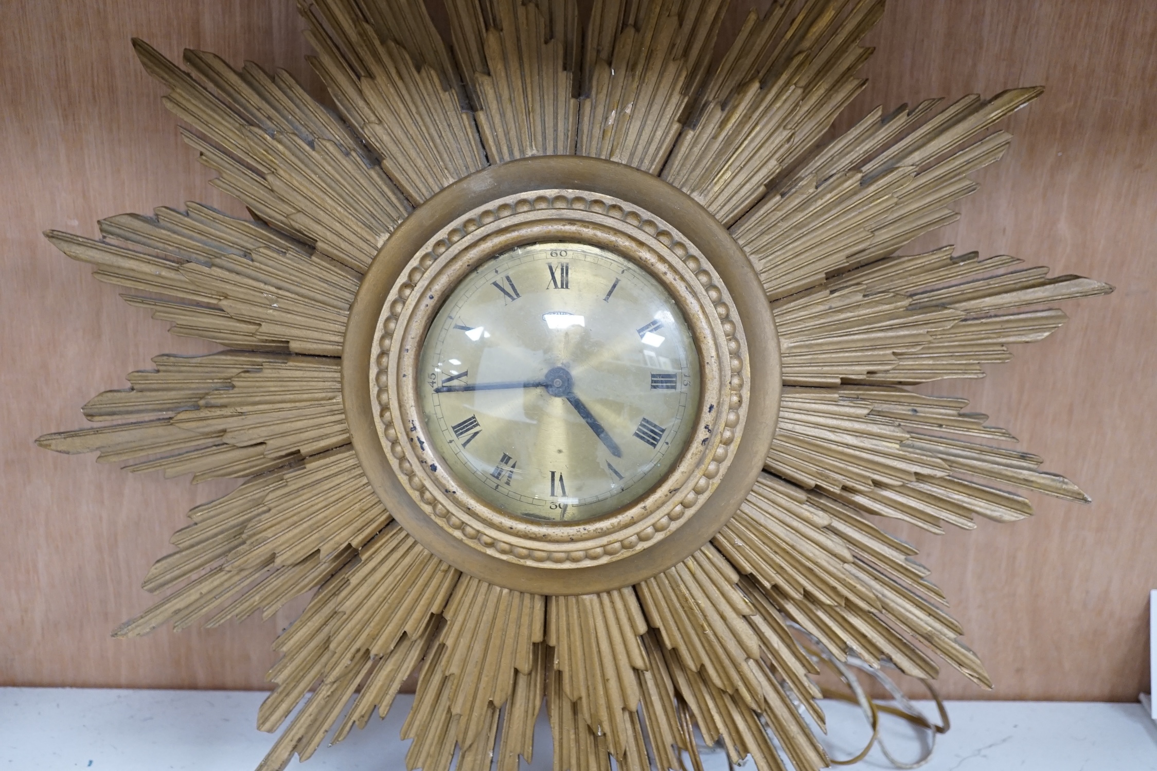 A Smiths sunburst wall clock and a similar Metamec clock, Smith clock 66cm wide